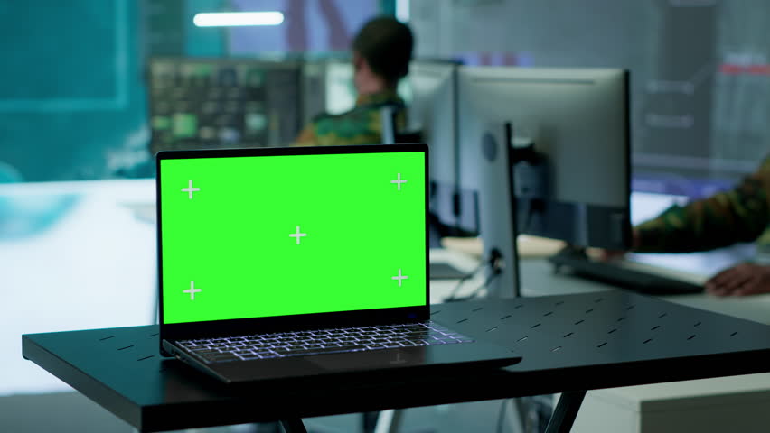 Army IT expert in control center collecting real time battlefield data, process satellite surveillance imagery for successful military defense mission. Using green screen isolated display. Camera A.