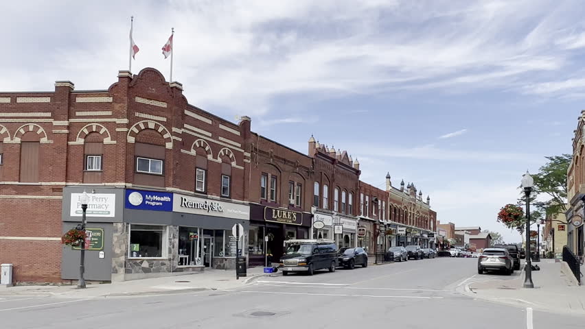  port perry, canada - august 17 2023: typical north american main street of a small countryside town with historic houses and cars parked