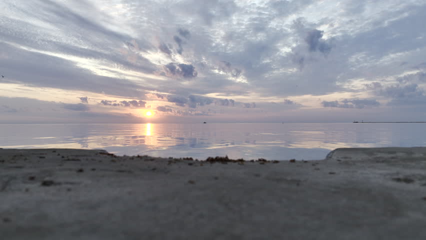 Breathtaking aerial view of a serene sunrise over Lake Michigan, near Chicago. With vibrant colors reflecting off the calm water and dramatic clouds in the sky. Perfect for nature and travel content.