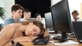 Exhausted students find solace in sleep, their heads resting on lecture hall desks during break. High quality 4k footage - Powered by Shutterstock - Get 15% off with code: PIKWIZARD15