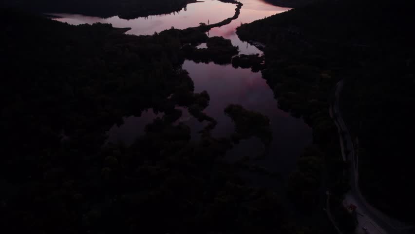 Aerial view of serene river and winding forest at dawn, Krka National Park, Croatia.