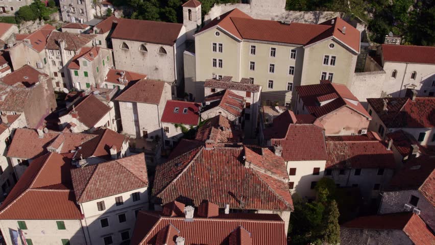 Aerial view of medieval town with church, harbor, and mountain, Kotor Bay, Montenegro.