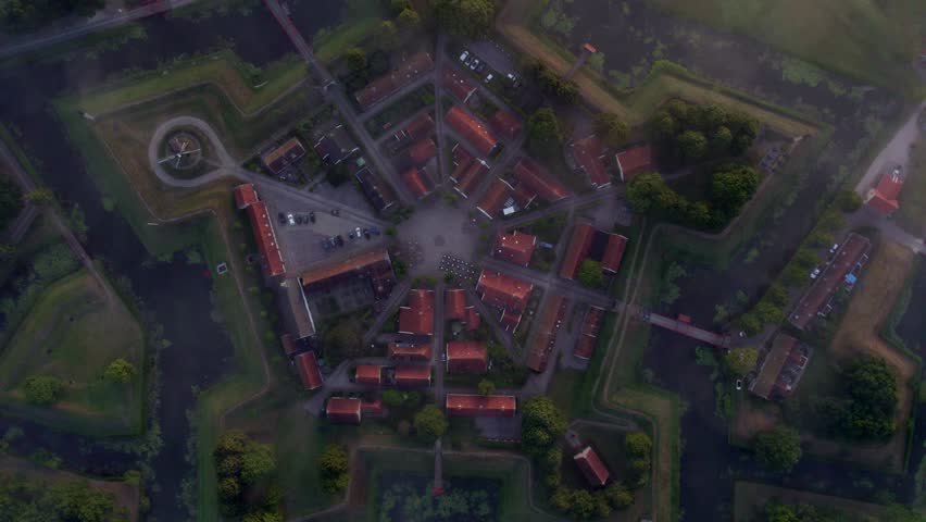 Aerial view of medieval fortress with windmill and misty morning fog, Bourtange, Netherlands.