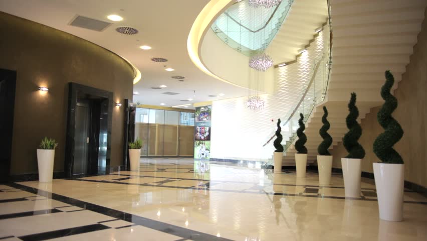 the women walks in a bulding, hotel entrance