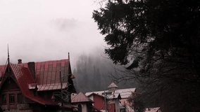 Mountain town with red-roofed houses and charming old buildings, perfect for winter vacations and alpine adventures. - Powered by Shutterstock - Get 15% off with code: PIKWIZARD15