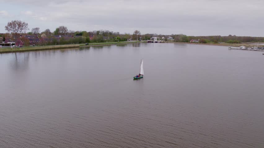 Aerial view of windmill, sailboat, river, and countryside, Anna Paulowna, North-Holland, Netherlands.