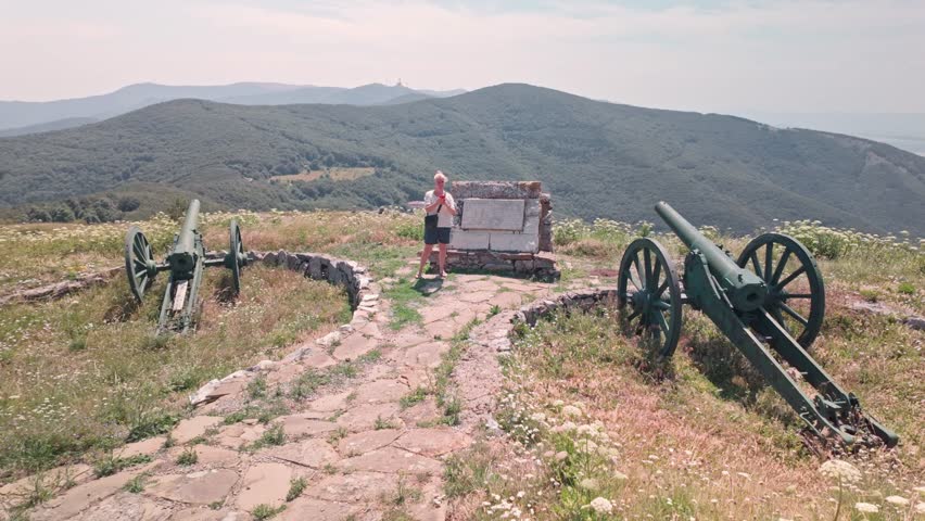 Female history Tourist visits Artillery gun defences, Shipka Pass battlefield landscape