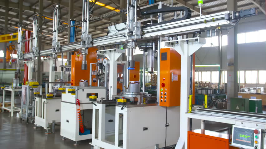 Real shot assembly line inside automated robotic assembly machine of motor coil in a factory production process automobile manufacturing plant
