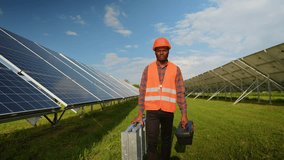 African American energy engineer in uniform checking solar panels while walking on field - Powered by Shutterstock - Get 15% off with code: PIKWIZARD15