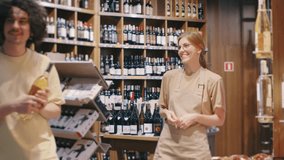 During a discussion in a liquor store, a customer and store clerk seek advice to choose the best wine bottle, engaging in an interaction for assistance and professional recommendations - Powered by Shutterstock - Get 15% off with code: PIKWIZARD15