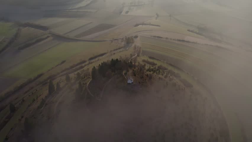 Aerial view of rural countryside with Salmendinger Kapelle church and hill, Burladingen, Germany.