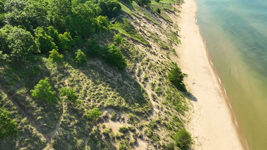 An aerial pass across the lush sand on Lake Michigan.