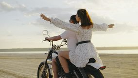 A carefree couple on a motorcycle enjoys a romantic moment at sunset by the beach, embodying love and adventure in their unforgettable journey together, creating lasting memories - Powered by Shutterstock - Get 15% off with code: PIKWIZARD15