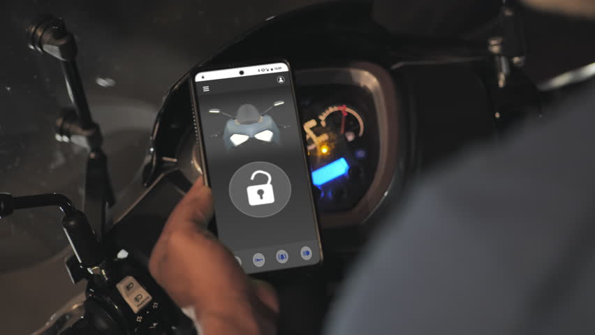 turning on bike using smart phone digital key app  keyless security system,man uses smartphone mobile application to unlock and turn on motorbike

