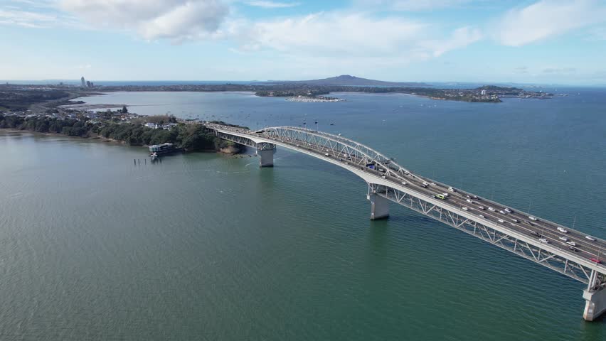 Traffic Over Auckland Harbour Bridge Towards Northcote Point In Auckland, North Island, New Zealand. Aerial Drone Shot