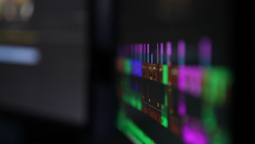 Concept of video editing on computer monitor. Closeup of video editor works on editing on desktop. Film maker fixed work of program for video processing, post-production. Shooting in slow motion.