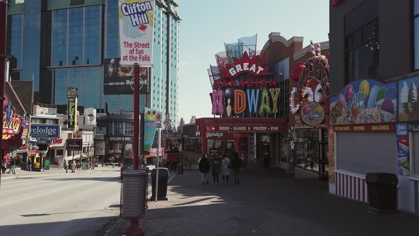 Niagara, CANADA - Feb 21 2024 : Daytime view of Clifton Hill, a popular tourist attraction near Niagara Falls, featuring vibrant signs, attractions, and tourists strolling.