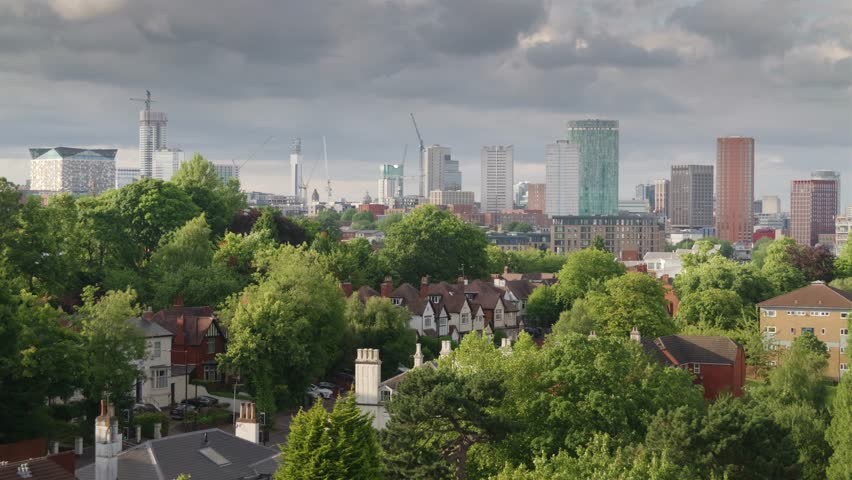Birmingham city centre skyline 2024.
Evening summer sun shines on the towers and cranes of Birmingham City centre and trees in Edgbaston.