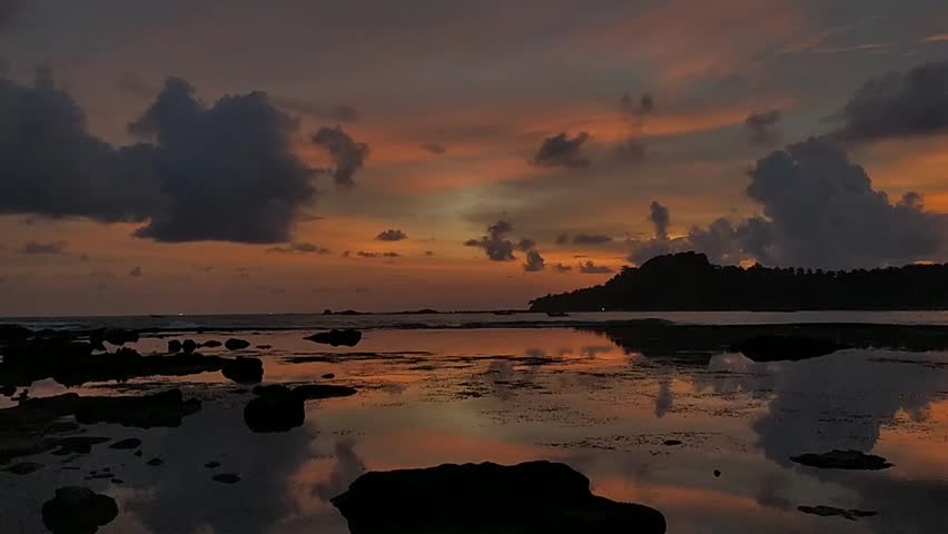 cloudy afternoon sky on a beautiful beach with a very wide expanse of coral