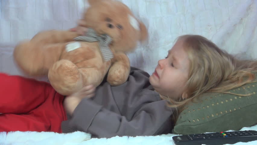 Sick Child Sneezing, Little Girl Playing with her Teddy Bear on the Sofa | Shutterstock HD Video #3554840