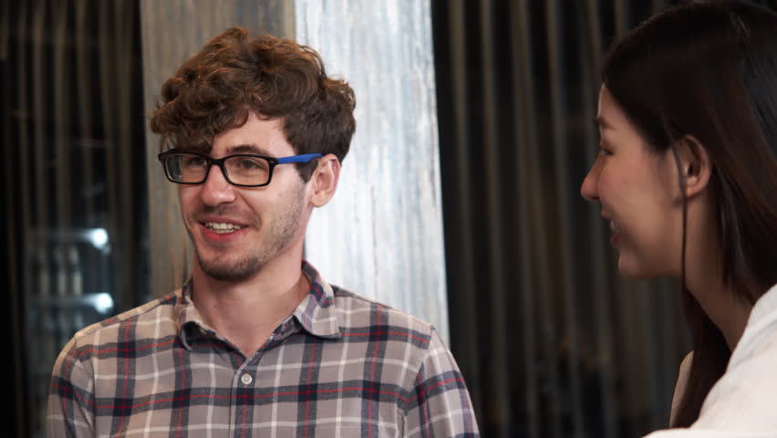 Friends having fun talking and laughing in coffeeshop.