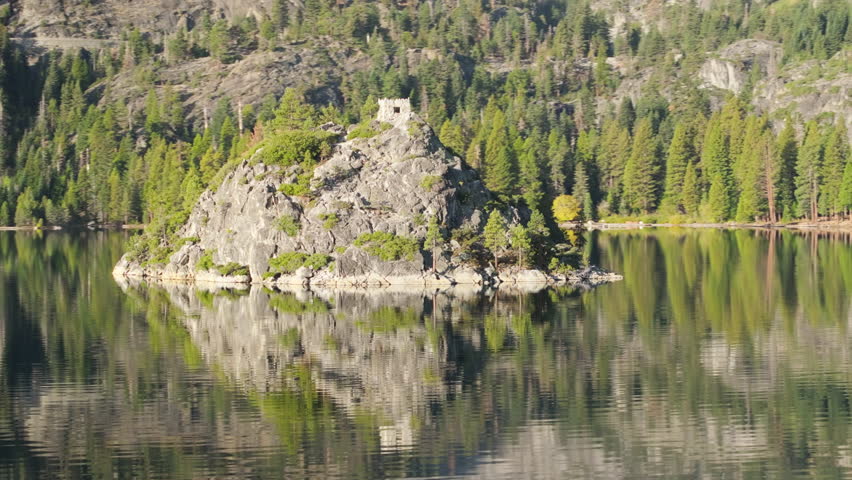 A large rock stands prominently in Lake Tahoe, California, USA, creating a striking scene against the waters surface. 4K footage.