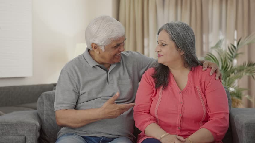 Happy Indian old couple talking and smiling