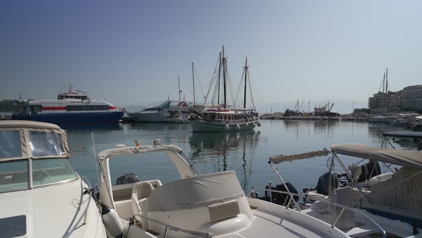 View of Old Port Marina and boat leaving port in the morning, Corfu Town, Corfu, Ionian Sea, Greek Islands, Greece, Europe