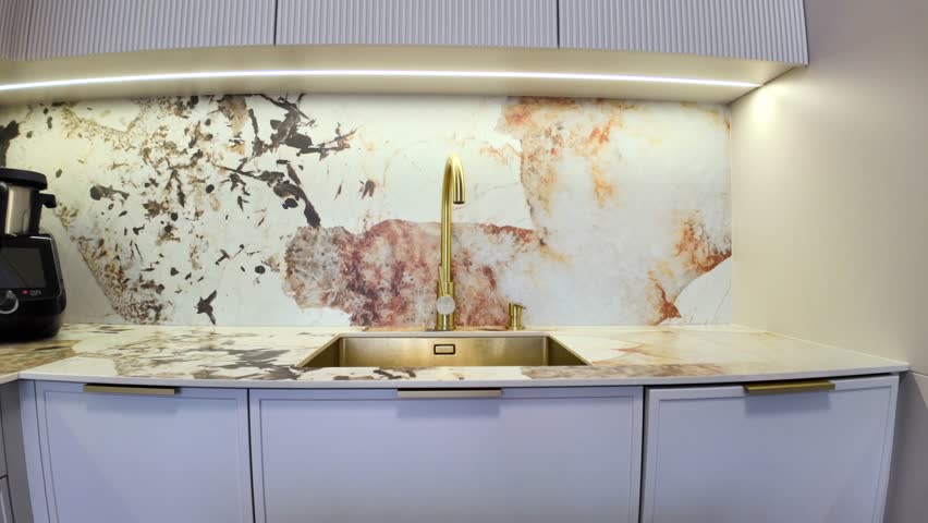 Gold faucet and sink, modern kitchen, cashmere color, real estate.