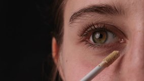 Close-Up Shot Of A Girl Applying Concealer Under Her Eyes And Makeup Foundation On Her Eyelids - Powered by Shutterstock - Get 15% off with code: PIKWIZARD15
