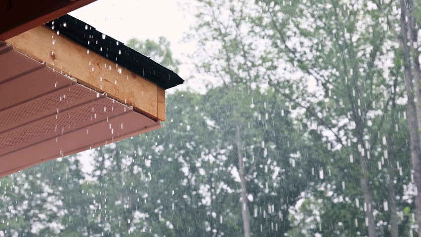 During heavy downpours, rainwater flows from roof of home