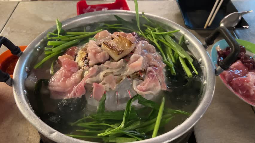 Street Thai barbecue , Thai barbecue Grill Pork on hot pan. Barbecue buffet pig pan and vegetables in soup.