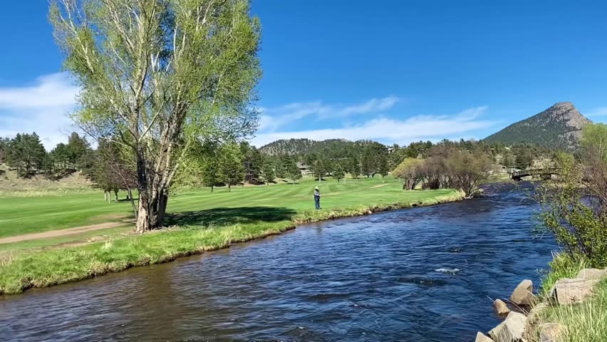 River surounded by meadows and mountains in Aspen Mountains, Colorado