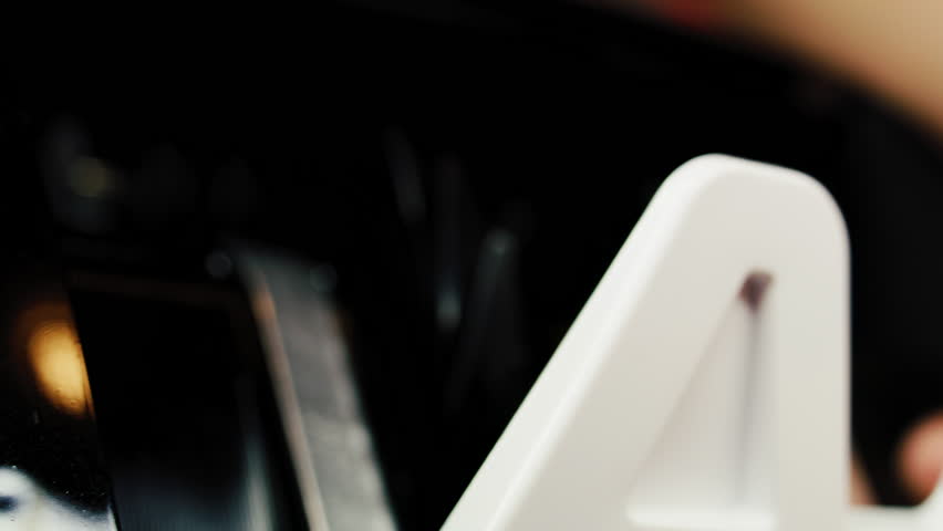 Money counting machine counts hundred dollar bank notes for currency exchange, budget calculation or investment. Automatic bill counter. 100 US dollar bills. Finance and banking concept. Close Up.