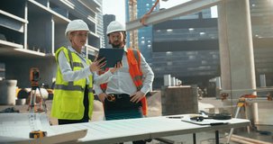 Female and Male Architects Using Augmented Reality Software on a Tablet Computer to Visualize and Plan a Construction Project. Holographic Interface Displays a Detailed 3D Model of the Building Site - Powered by Shutterstock - Get 15% off with code: PIKWIZARD15