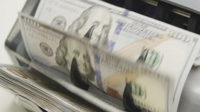 Close-Up of Money Counting Machine with Hundred Dollar Bills - Powered by Shutterstock - Get 15% off with code: PIKWIZARD15