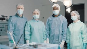 Diverse surgical team in operating room give a thumbs up - Powered by Shutterstock - Get 15% off with code: PIKWIZARD15