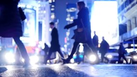 A vibrant city street at night with silhouettes of pedestrians and illuminated buildings - Powered by Shutterstock - Get 15% off with code: PIKWIZARD15