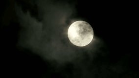 Full Moon casting a serene glow over the night sky, illuminated by dramatic clouds - Powered by Shutterstock - Get 15% off with code: PIKWIZARD15