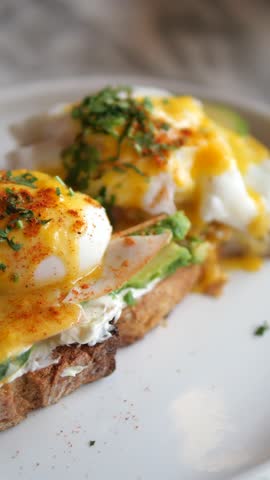 Eggs Benedict with ham on a plate. Delicious breakfast. 