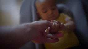 A touching scene depicted through a parent gently holding the babys hand in a closeup view - Powered by Shutterstock - Get 15% off with code: PIKWIZARD15