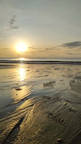 Vertical footage of fishing boat against sunrise at muddy beach. concept of nature and mode of transportation