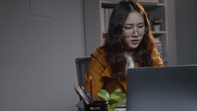 Focused businesswoman works late in her office on a laptop, surrounded by a stack of paperwork. Her dedication and productivity shine in this corporate environment - Powered by Shutterstock - Get 15% off with code: PIKWIZARD15