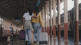 Two friends stroll at a train station, one with a suitcase, the other arm in arm. They enjoy their journey together, creating a sense of companionship and adventure - Powered by Shutterstock - Get 15% off with code: PIKWIZARD15