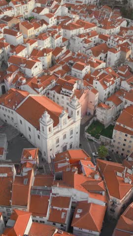 Aerial view of Lisbon downtown at sunrise, Portugal. Drone footage of the Lisbon old town skyline. Historical district Alfama at sunrise in capital city of Portugal. Historic buildings of Lisboa city