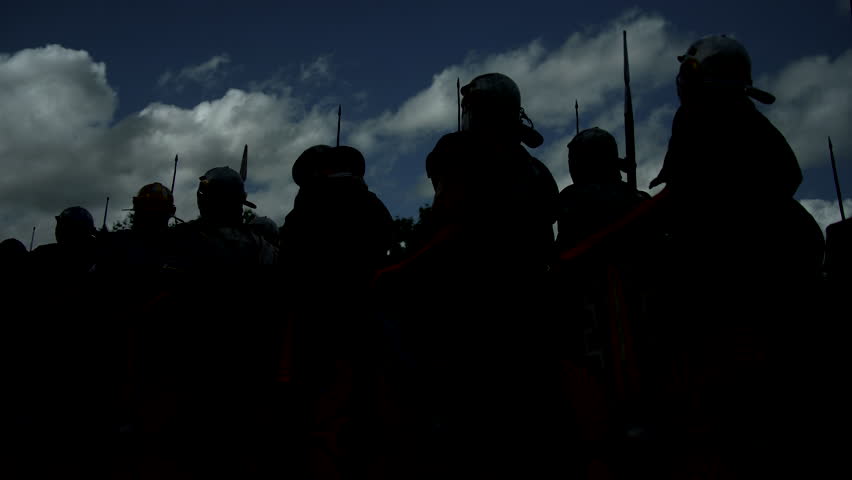 Riot Police in silhouette under a dramatic cloudy sky, ready for crowd control and maintaining order