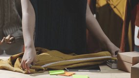 The designer is working and selecting colors for the clothing design in a good mood smiling with happiness at creating the work - Powered by Shutterstock - Get 15% off with code: PIKWIZARD15