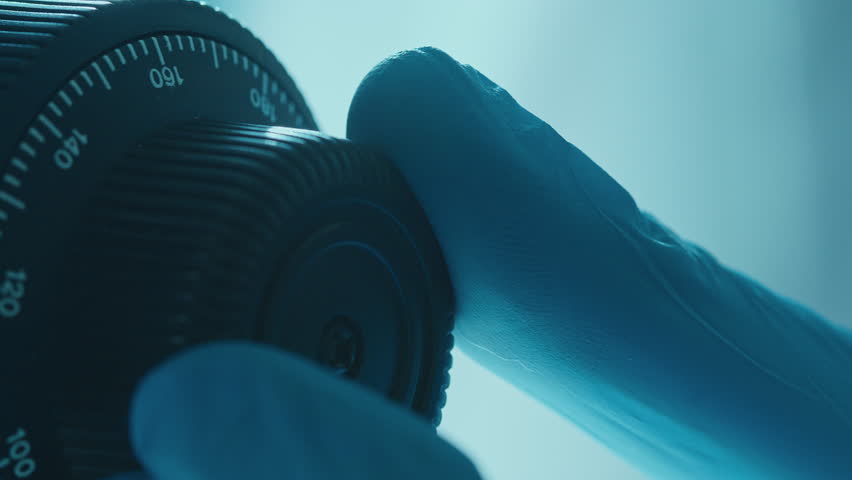 Gloved hand of laboratory worker adjusting focus knob of microscope during research. Extreme close-up shot - Powered by Shutterstock - Get 15% off with code: PIKWIZARD15