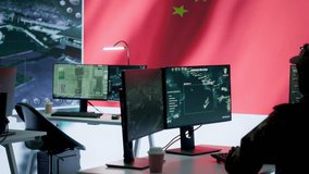 Military analyst from China reviews surveillance data in an army monitoring room headquarters. Chinese soldiers spreading misinformation through propaganda, presenting the national flag. Camera A. - Powered by Shutterstock - Get 15% off with code: PIKWIZARD15
