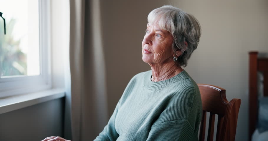 Lonely, senior woman or remember with thinking of memory, mental health or nostalgia with dementia in retirement. Alzheimer, elderly person and thoughtful with reflection and worried in nursing home